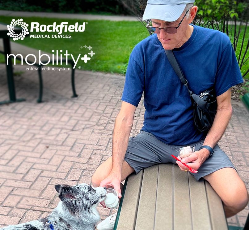 Andy feeding his dog